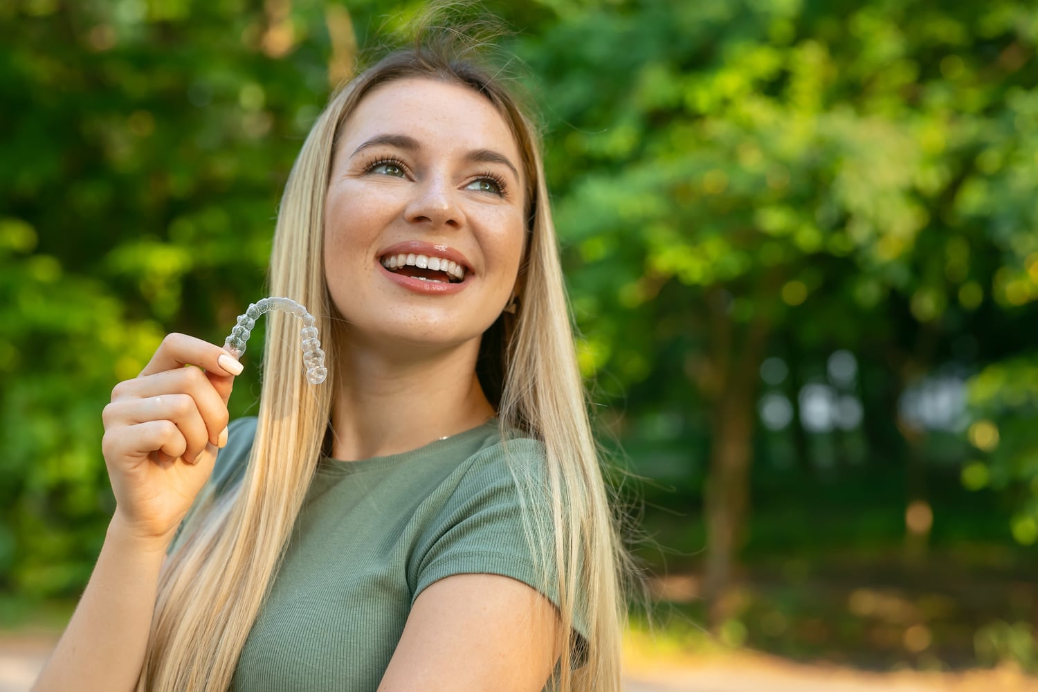Woman with clear dental aligners in Lindenhurst