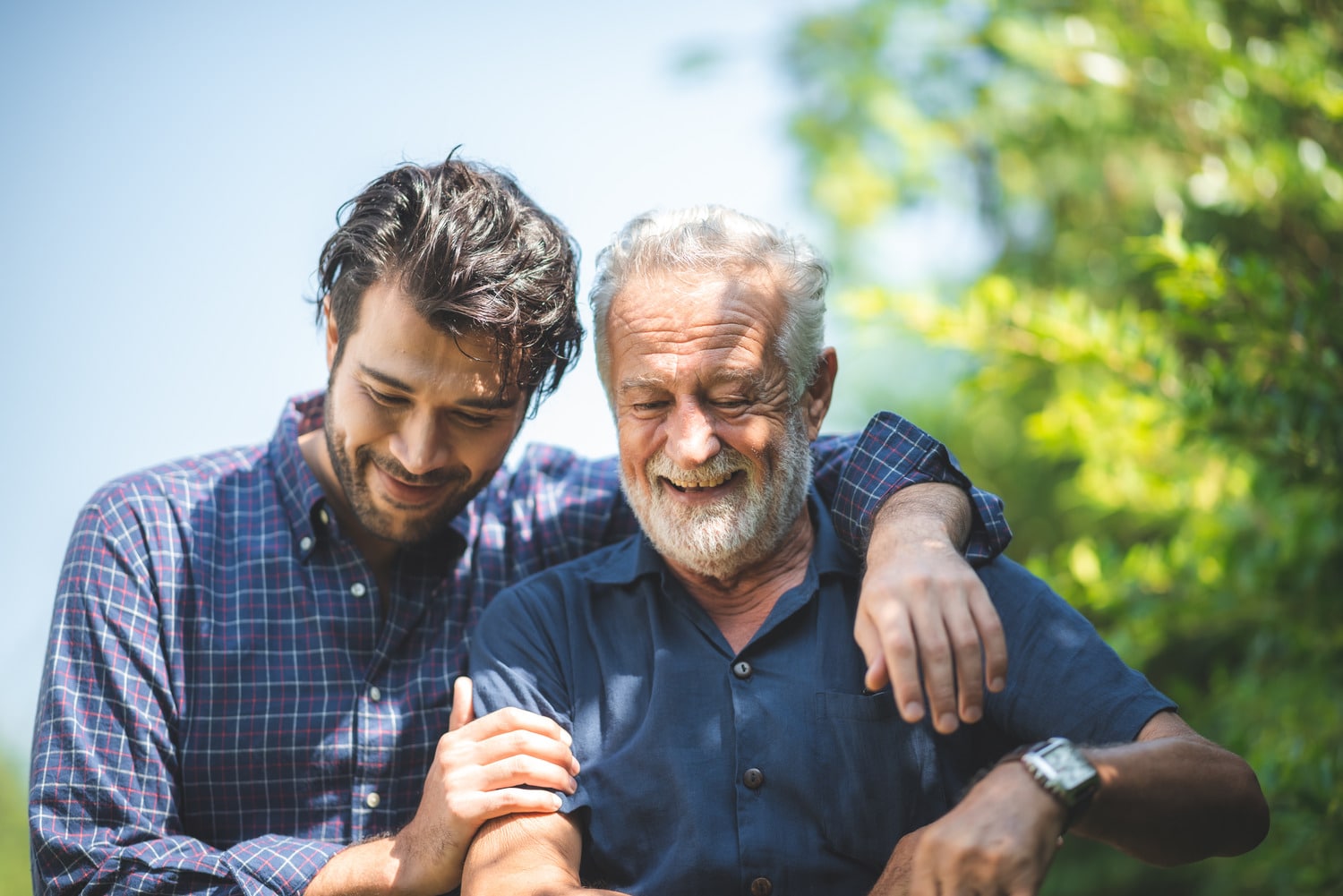 Man and his son celebrate together after denture treatment in Lindenhurst