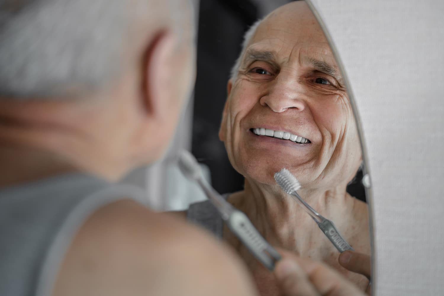 Man cleans his dentures in Lindenhurst IL